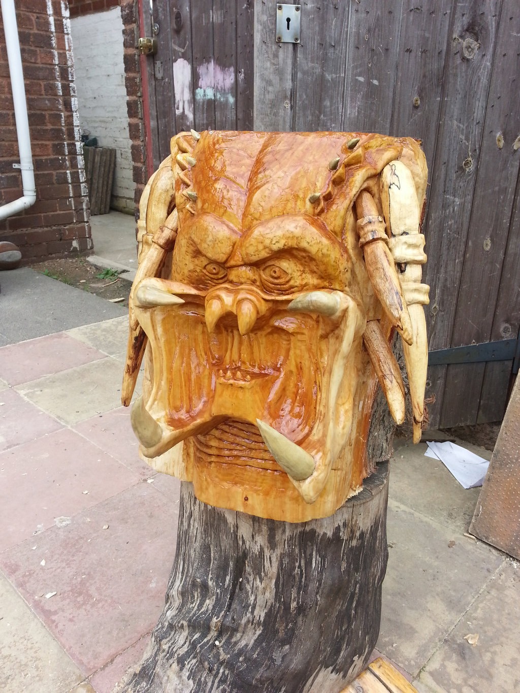 An Extraterrestrial Predator Head Carved From A Humongous Tree Stump