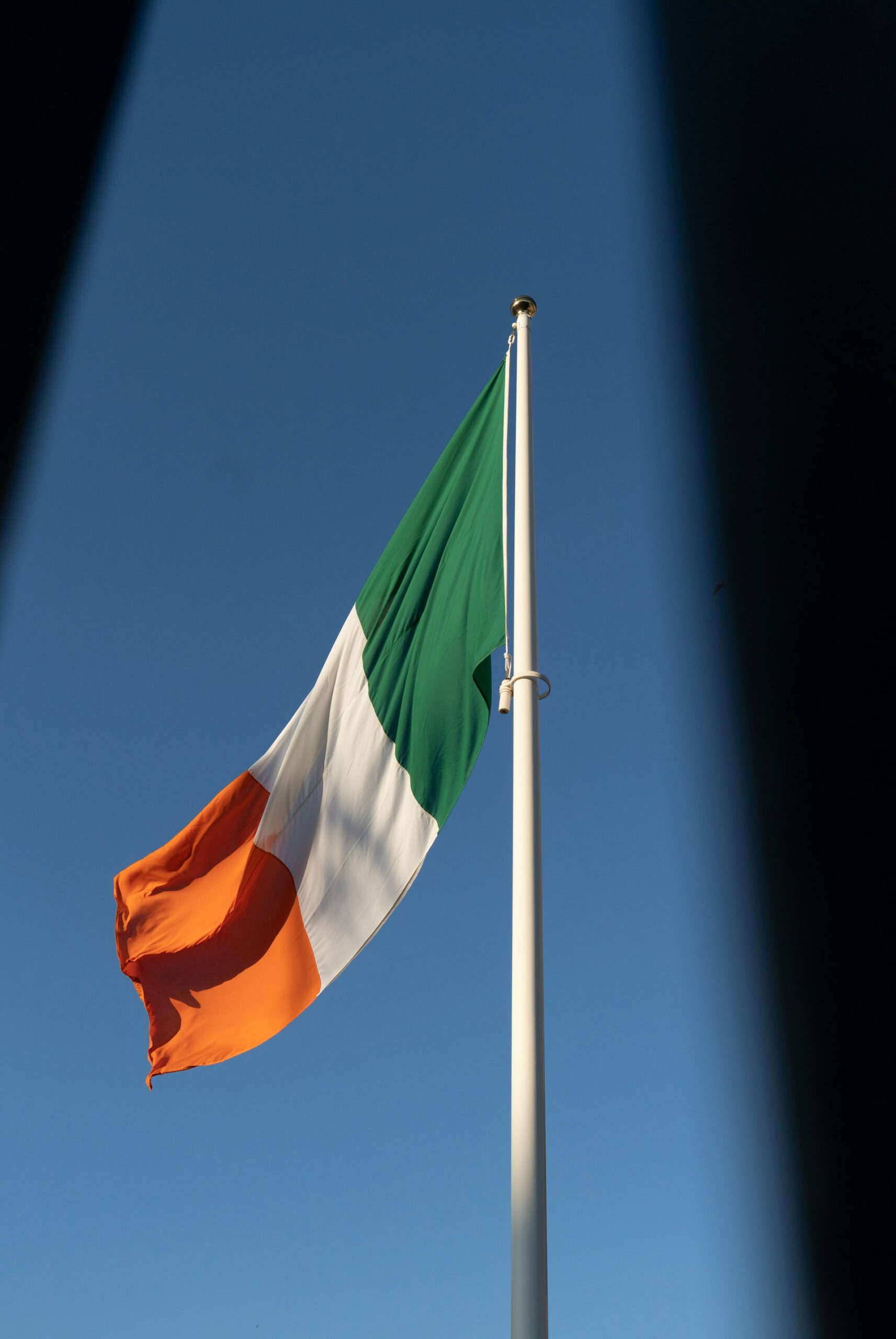 A national flag waving outdoors, representing Ireland’s legal protections for workers who experience workplace injuries or unfair dismissal.