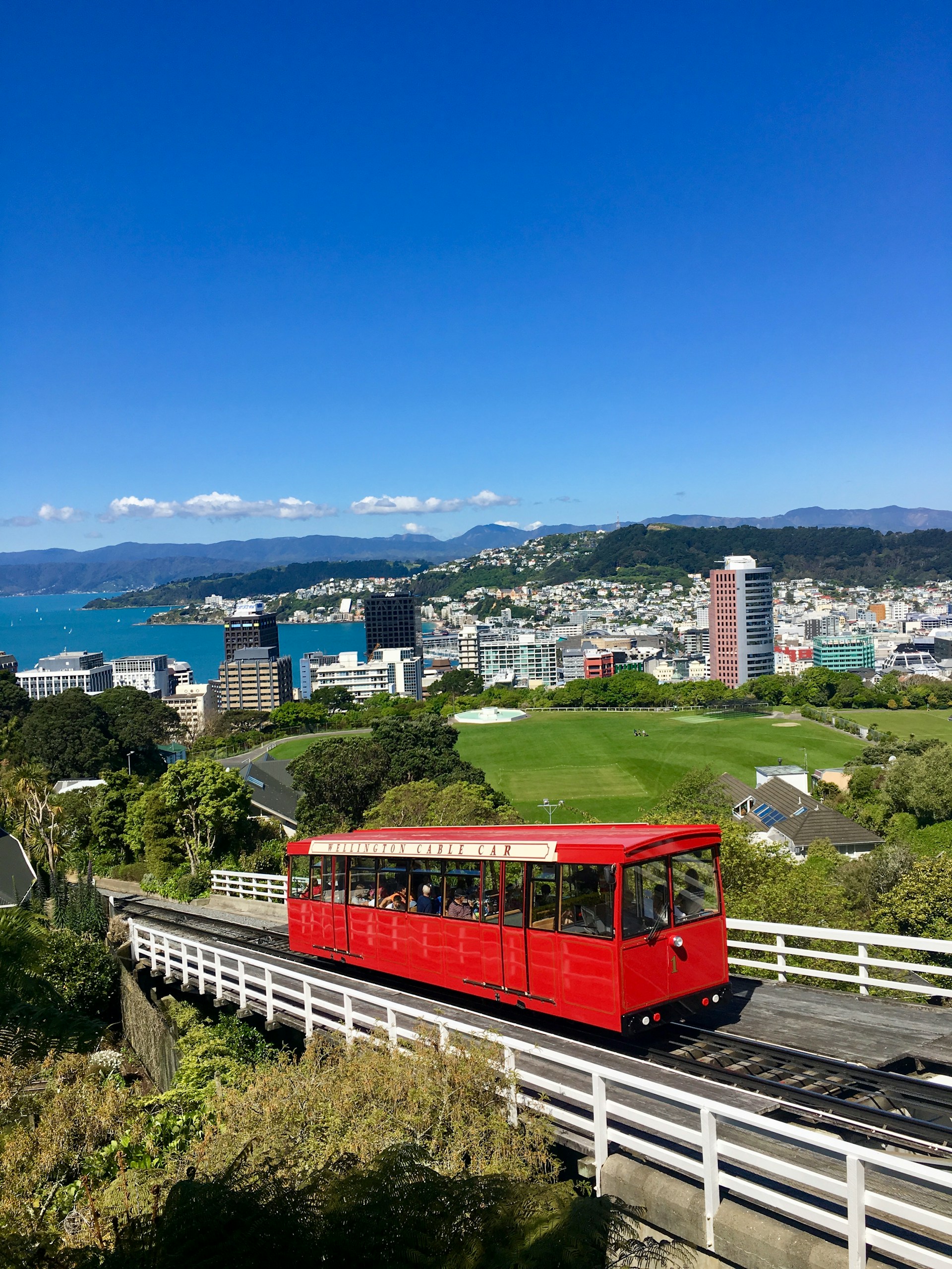 Red Train on Railway with Cityscape – Urban Transit & Travel Photography