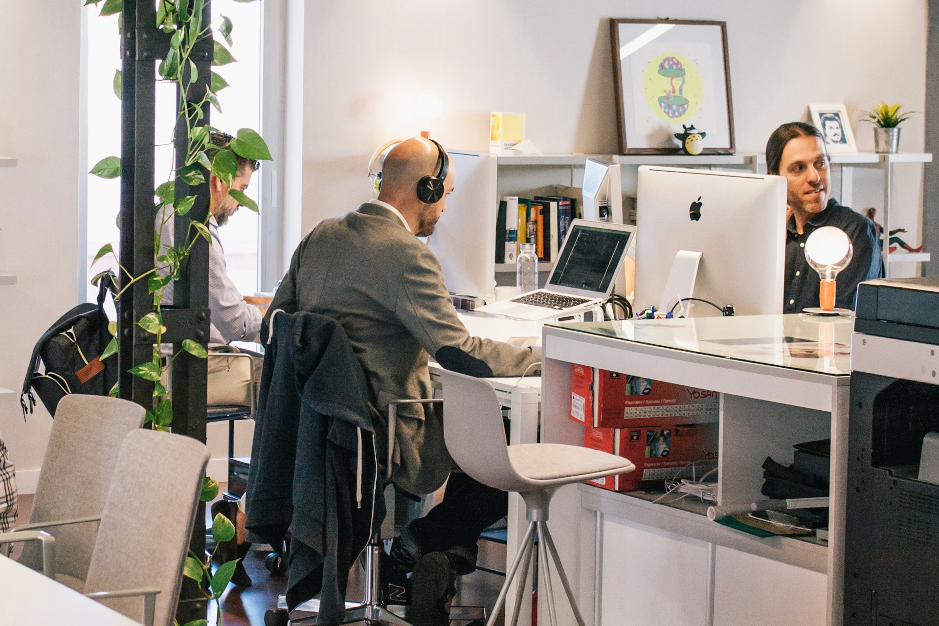 Three Men Sitting on Individual Chairs Indoors