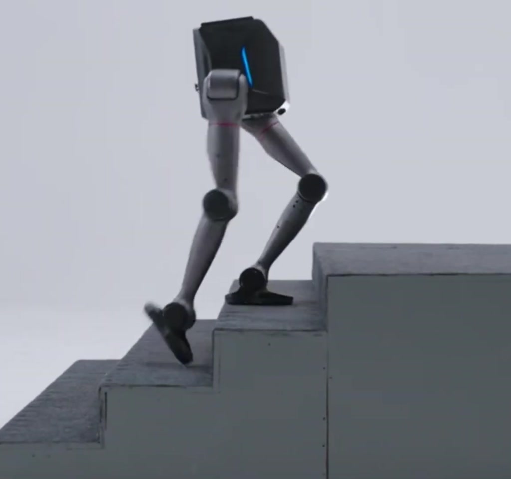 Vertical studio portrait of the Tron 2 humanoid robot standing upright with a white shell, articulated limbs and illuminated sensors