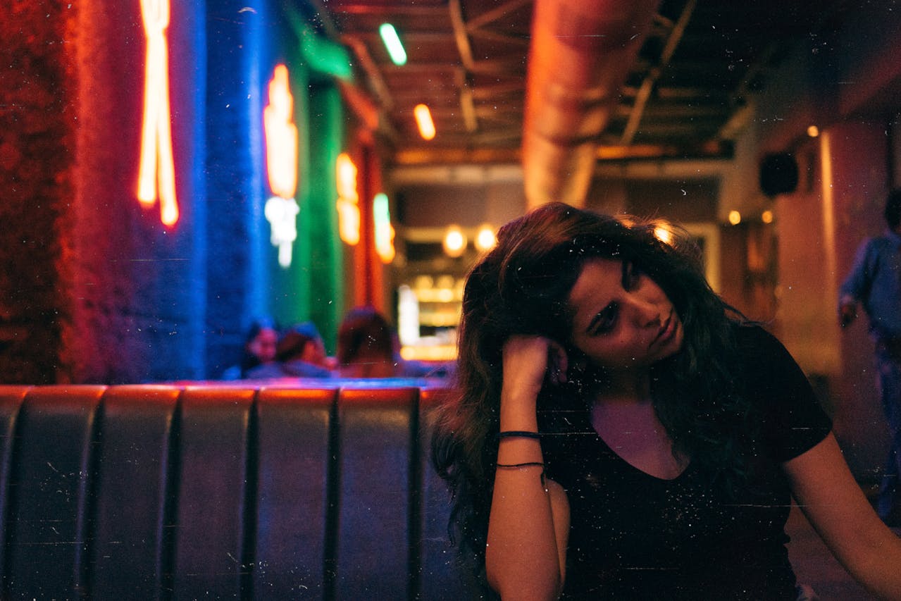 Woman Sitting In A Restaurant Booth