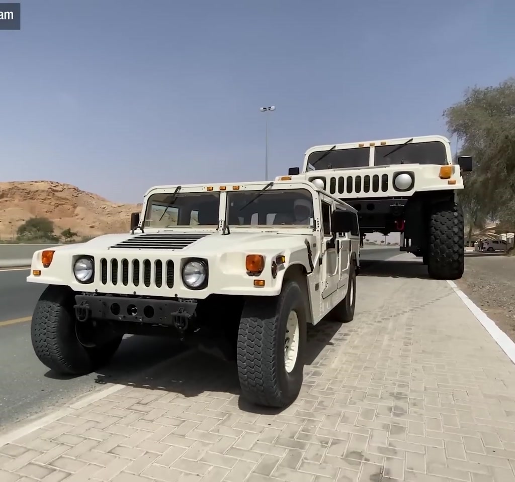 Vertical portrait of the Hummer H1X3 converted into a two-story drivable duplex with extended body, exterior staircase and balcony