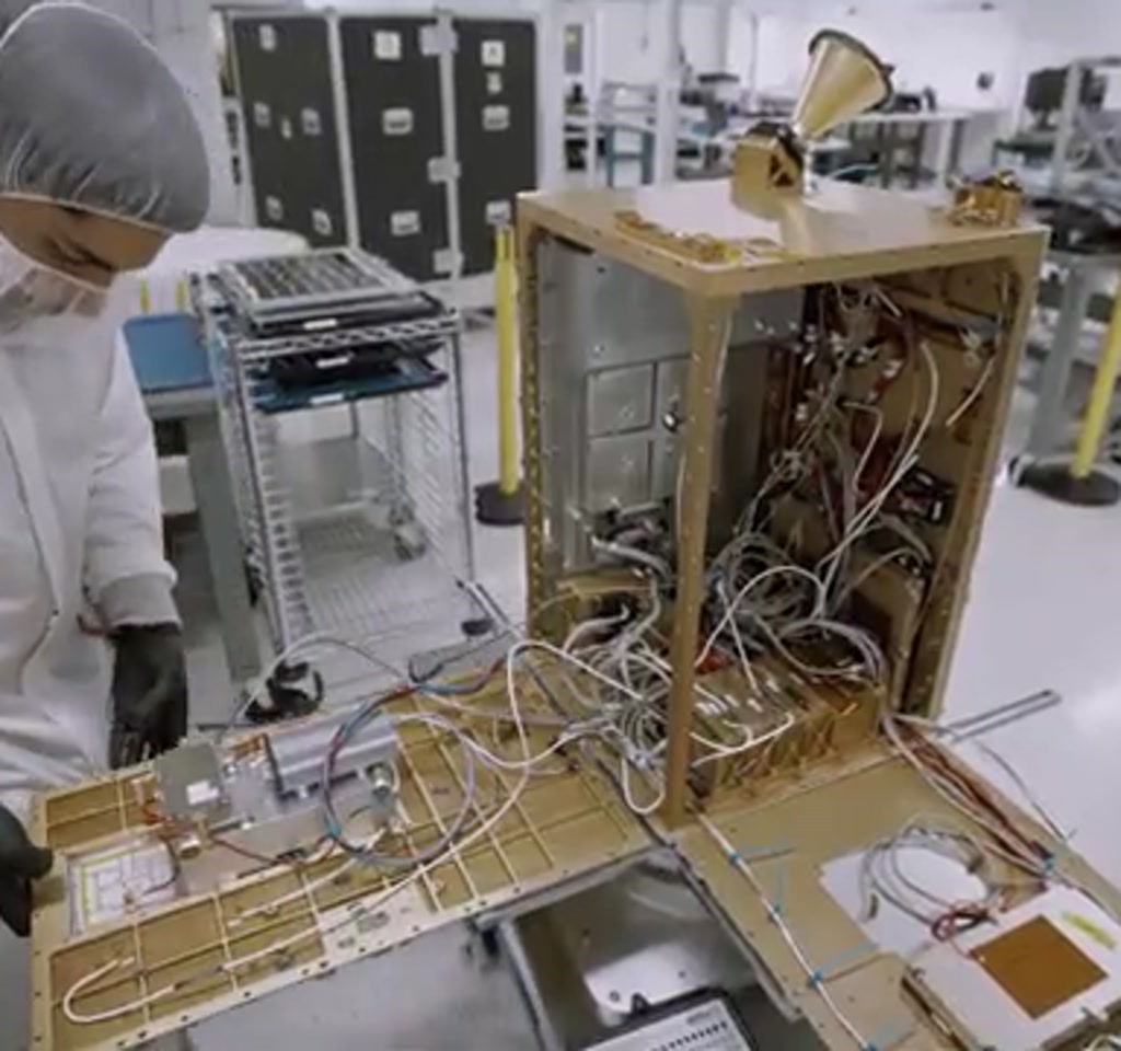 Vertical image of a satellite carrying server racks and solar panels sending data streams toward Earth